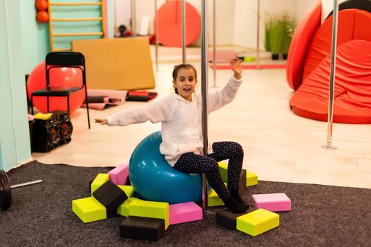 closeup of little gymnast girl doing exercises