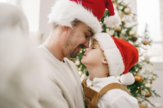 Young dad and his son celebrate christmas together, portrait