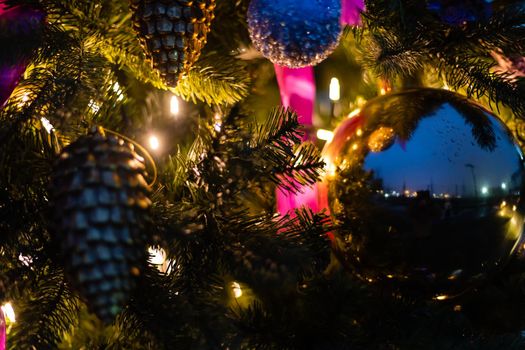 Christmas decorations : purple ball hanging on branch of fir tree