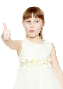 Little girl holding her thumb up. Concept Happy childhood, holiday, birthday.Isolated on white background