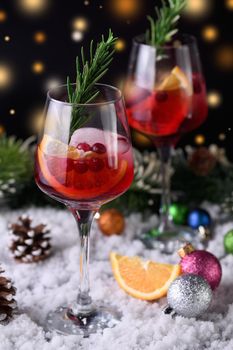 Cocktail Margarita with cranberries, orange and rosemary. A perfect cocktail for a Christmas party