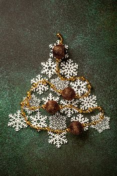 Overhead shoot of wooden christmas tree and decoration. Winter holidays background with copy space, flat lay, top view.