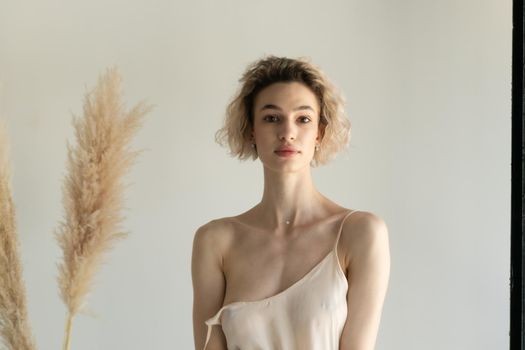 young beautiful woman posing in white lingerie in studio