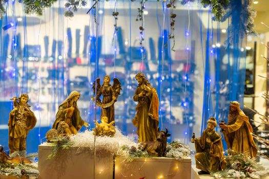 Christmas nativity scene photograph of Mary, a king, a shepherd and lamb worshipping baby Jesus.
