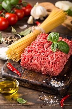 Healthy food background with ingredients for spaghetti Bolognaise or Bolognese with savory minced beef and tomato, basil and spices.