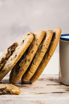 Chocolate chip cookies on old white wooden cutting board. American cuisine. Copy space.