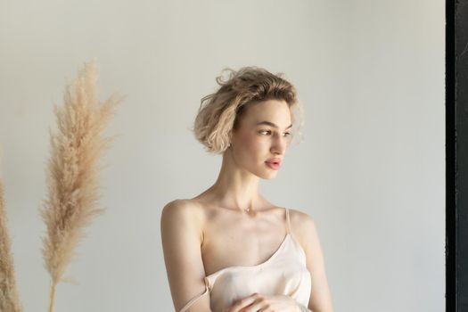 young beautiful woman posing in white lingerie in studio