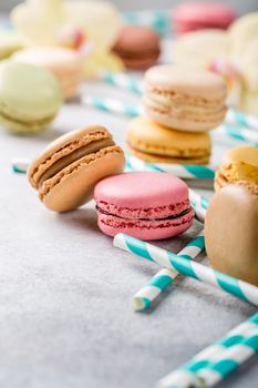 French assorted macarons on light gray concrete background. Holidays food concept. Copy space.