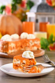 Slice of Pumpkin and cottage cheese casserole on a plate. This is a delicious dessert filled with autumnal notes. It is full of pumpkin spice aromas, creamy softness with raisins.