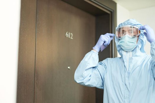 Cropped photo of man putting on safety glasses before entering the room. Coronavirus and quarantine concept