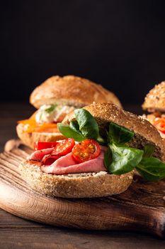 Sandwiche with beef, fresh tomatoes and lamb's lettuce, multigrain bun. Healthy lunch concept with copy space
