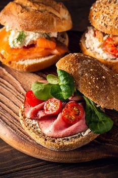 Sandwiche with beef, fresh tomatoes and lamb's lettuce, multigrain bun. Healthy lunch concept with copy space