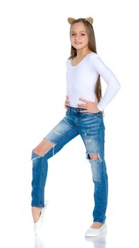 Beautiful teen girl in jeans with holes. Concept of happy childhood, fashion and style. Isolated on white background.