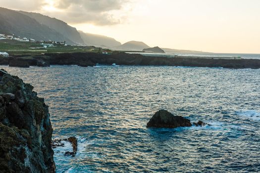 A body of water with a mountain in the background. High quality photo