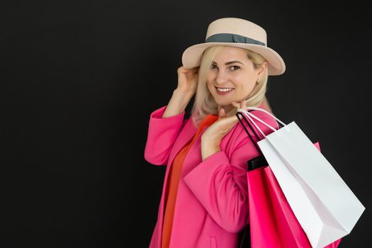 Elegant woman holding black shopping bags, black friday concept