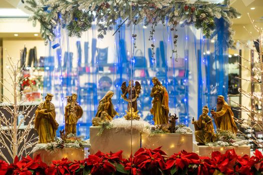 Christmas nativity scene photograph of Mary, a king, a shepherd and lamb worshipping baby Jesus.