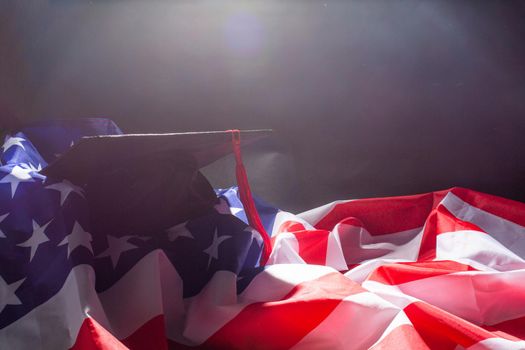 graduation hat on US flag, education concept