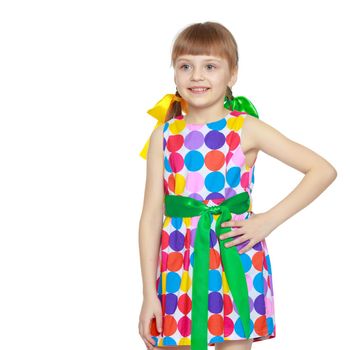 A sweet little blonde girl with long pigtails, in which large colored bows are braided, and a short bangs on her head. In a short summer dress.She gestures.