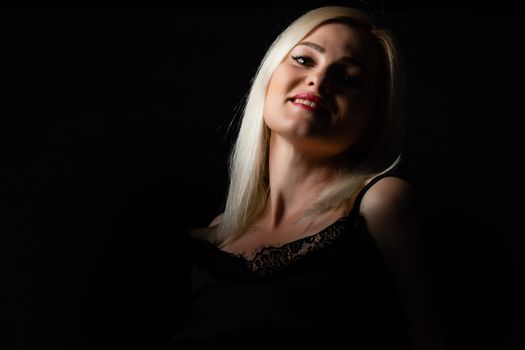 Beautiful blond woman on black