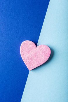 Valentine's Day background. Pink heart over blue. Valentines day concept. Flat lay, top view, copy space