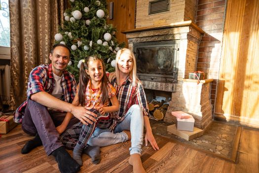 family and christmas tree in an old wooden house