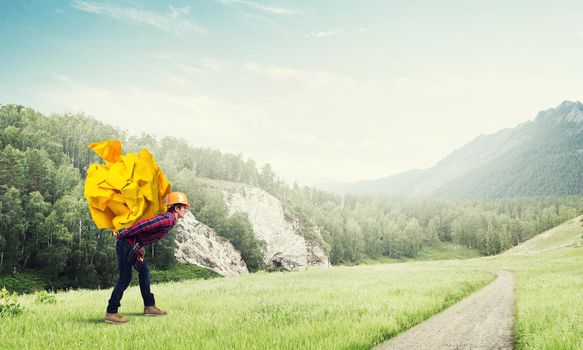 Builder man carrying paper ball on his back