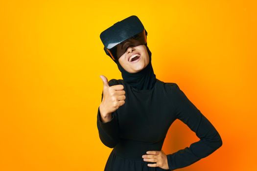 Muslim virtual reality glasses entertainment yellow background. High quality photo
