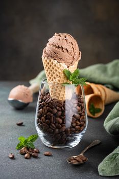 Delicious summer dessert coffee ice cream in waffle cone. Summertime healthy food concept, lactose free. Copy space.