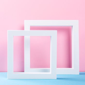 Composition of different geometric objects white frames for products presentation or exhibitions. Colorful abstract background multicolored, light blue, pink. Trend Concept with copy space.