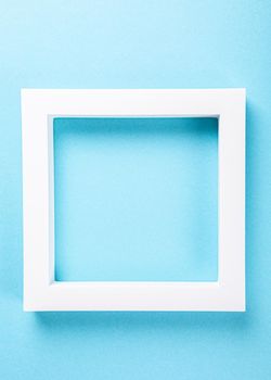 White foam frame on pastel blue background design. Minimal border composition with copy space. Moke up for presentation