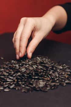 natural product sunflower seeds handing close-up food. High quality photo