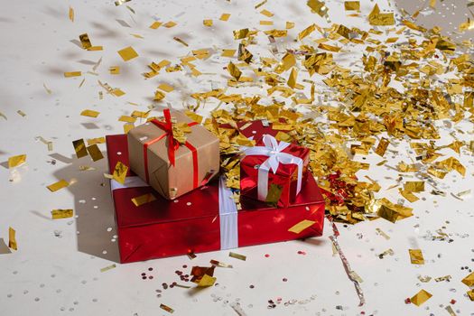 boxes with a presents in a beautiful pack with a lot of gold confetti around them