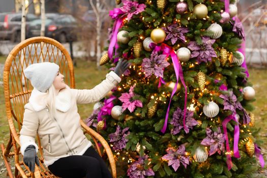 woman and christmas tree on the street