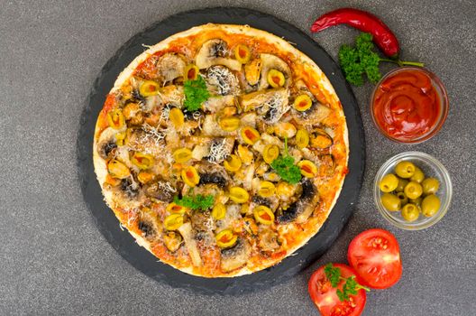 Pizza with mussels, mushrooms, green olives Photo