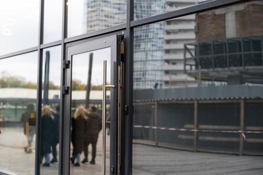 Outside solid glass door with building exterior.