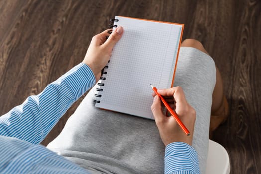 close-up a female hands with notebook and pencil