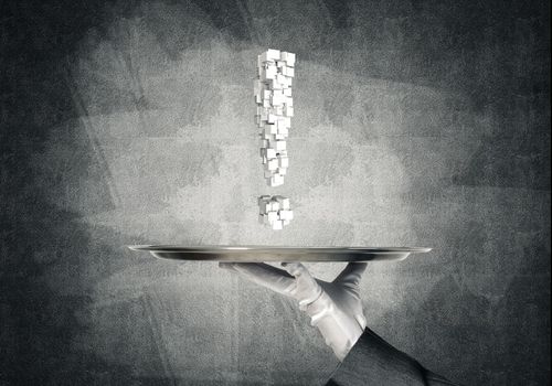 Cropped image of waitress's hand in white glove presenting multiple cubes in form of exclamation mark on metal tray