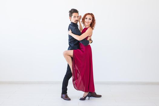 Romantic, social dance, people concept - couple dancing the salsa or kizomba or tango on white background.