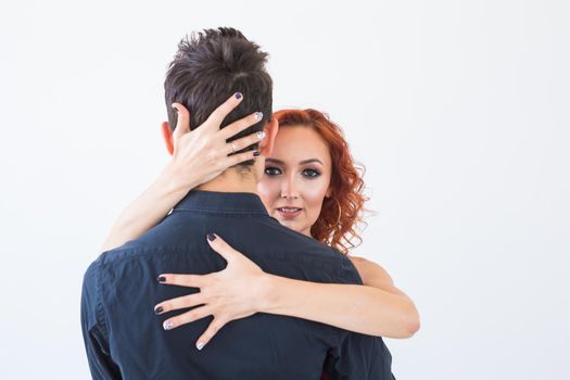 Social dance, bachata, kizomba, salsa, tango concept - Close up portrait of woman man dressed in beautiful outfits over white background.