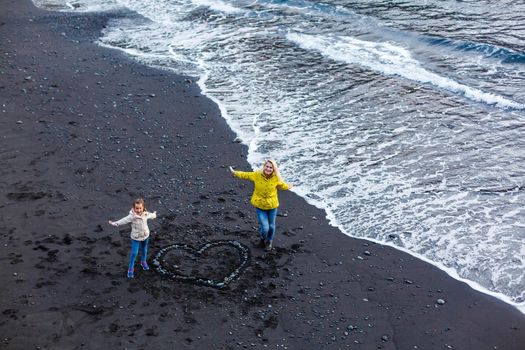 Family holiday on Tenerife, Spain, Europe. Mother and daughter outdoors on ocean. Portrait travel tourists - mom with child. Positive human emotions, active lifestyles. Happy young family on sea beach