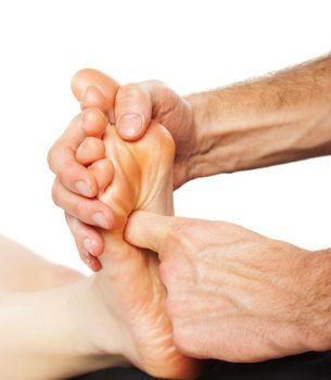 Closeup of foot receiving massage on white