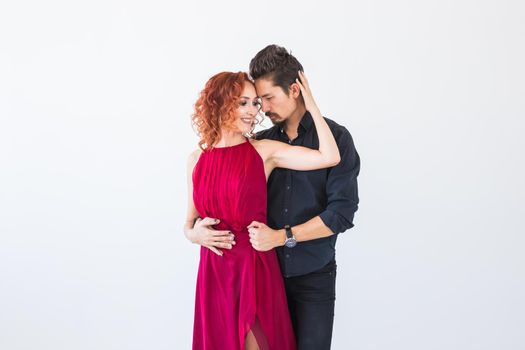 Social dance, bachata, kizomba, salsa, tango concept - Close up portrait of woman man dressed in beautiful outfits over white background.