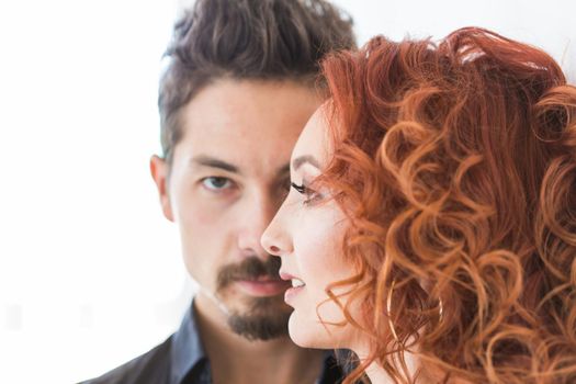 People and love concept - Head shot portrait of couple with serious faces over white wall.