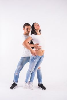 Young couple dancing social latin dance bachata, merengue, salsa. Two elegance pose on white background.