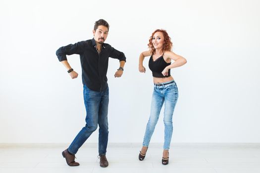 Social dance concept - Crazy dancing, cheerful couple over white background.