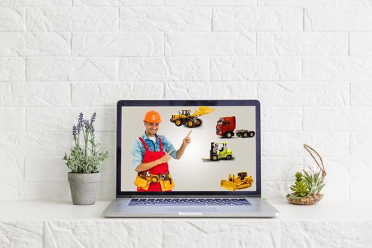 Portrait of happy repairman on laptop screen