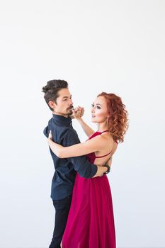 Romantic, social dance, people concept - couple dancing the salsa or kizomba or tango on white background.