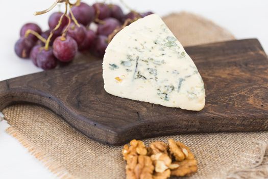 Blue cheese or brie with grapes and nuts.