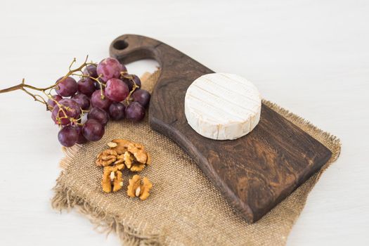 Blue cheese or brie with grapes and nuts.