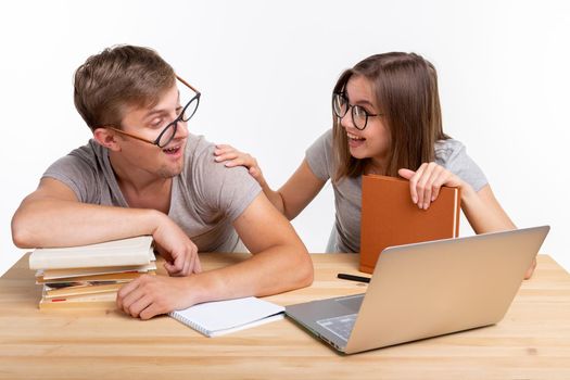 Education and student concept - a couple doing exercises or homework with laptop.